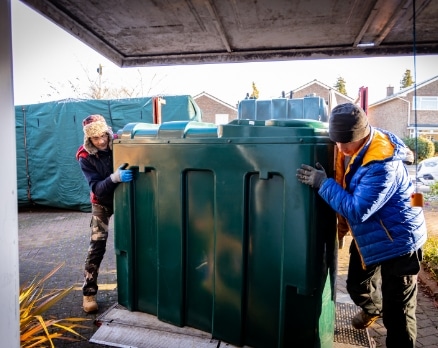 oil tanks plus engineers installing a domestic oil tank