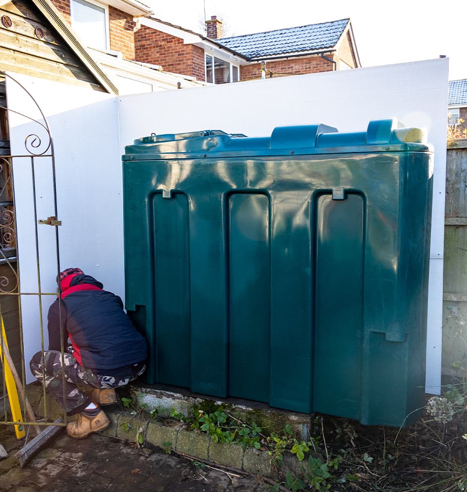 engineer installing an oil tank fire safety screen